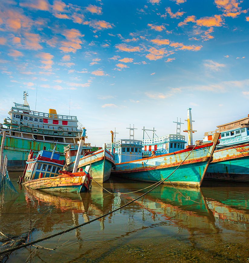 Many boats moored in sunrise morning time at Chalong port, Main port for travel ship to krabi and phi phi island, Phuket, Thailand