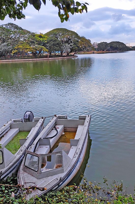 Beautiful lake view with magnificent evening clouds and boats. Ulsoor lake in the city of Gardens, Bangalore, India.