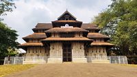 Vadakkumnathan or lord shiva ancient old traditional style south indian hindu religion stone temple building in kerala, thrissur. Front view with Om Namah Shivaya Mantra text in Malayalam language.