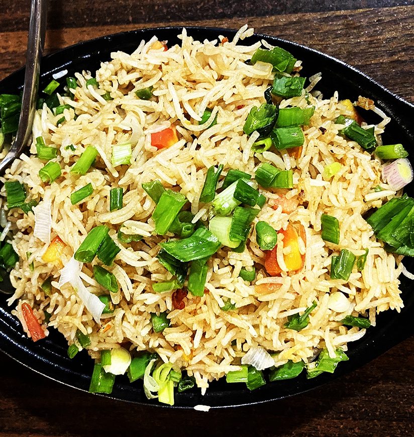 Vegetable Fried Rice is a culinary symphony of fluffy rice grains mingled with an assortment of colorful diced vegetables, sautéed to perfection. A harmonious balance of textures and flavors.