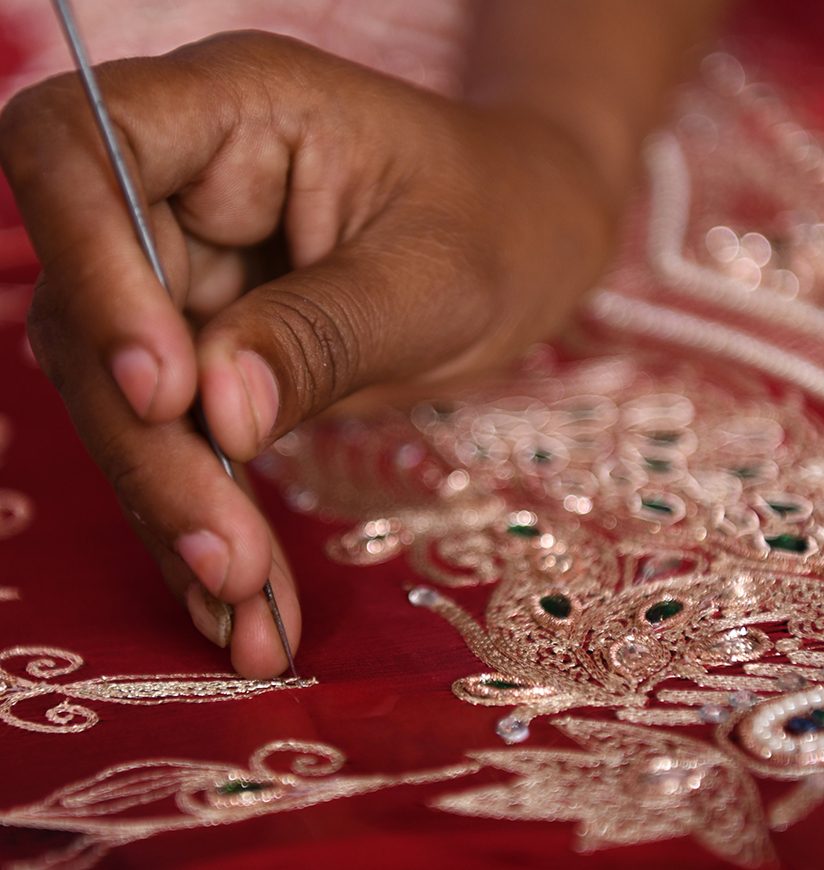 Girl hand Making of zari embroidery. Zari work is done with a hooked awl kind of needle called Aari.