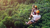 Zipline is an exciting adventure activity. Man and woman hanging on a rope-way. Tourists ride on the Zipline through the canyon of the Tara River Montenegro. Couple in helmets is riding on a cable car