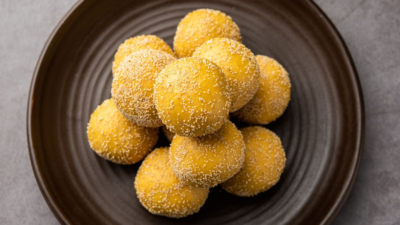 Golden sesame-coated dessert balls on plate