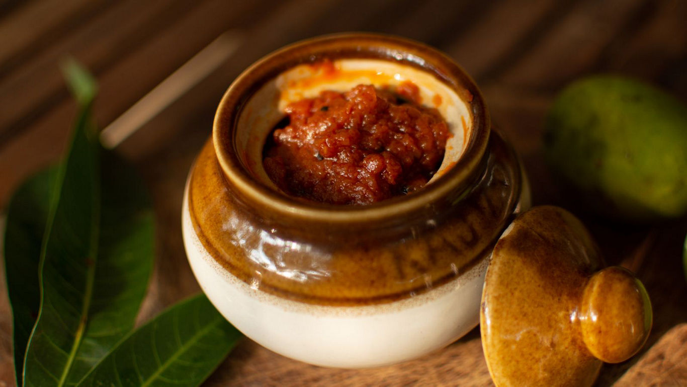 Rustic ceramic jar filled with chutney