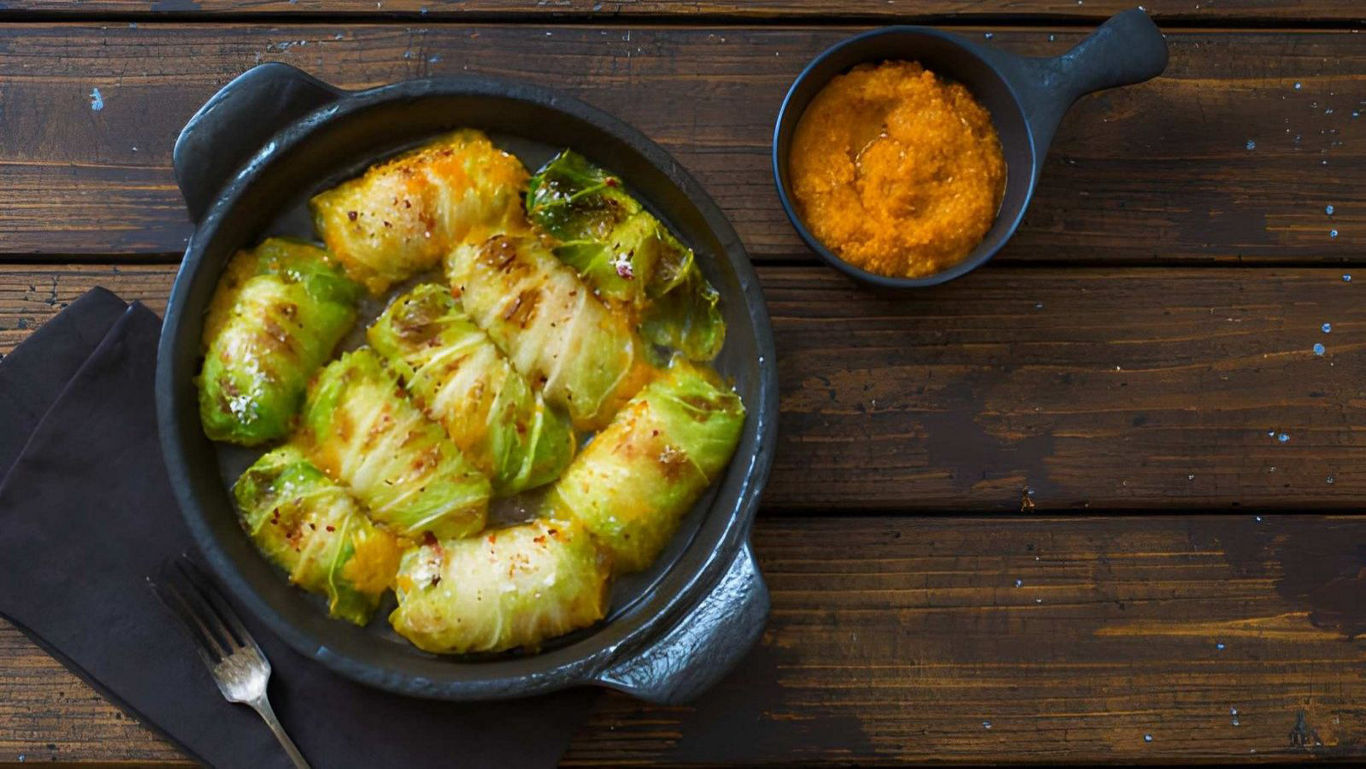 Stuffed cabbage rolls served in rustic black dish