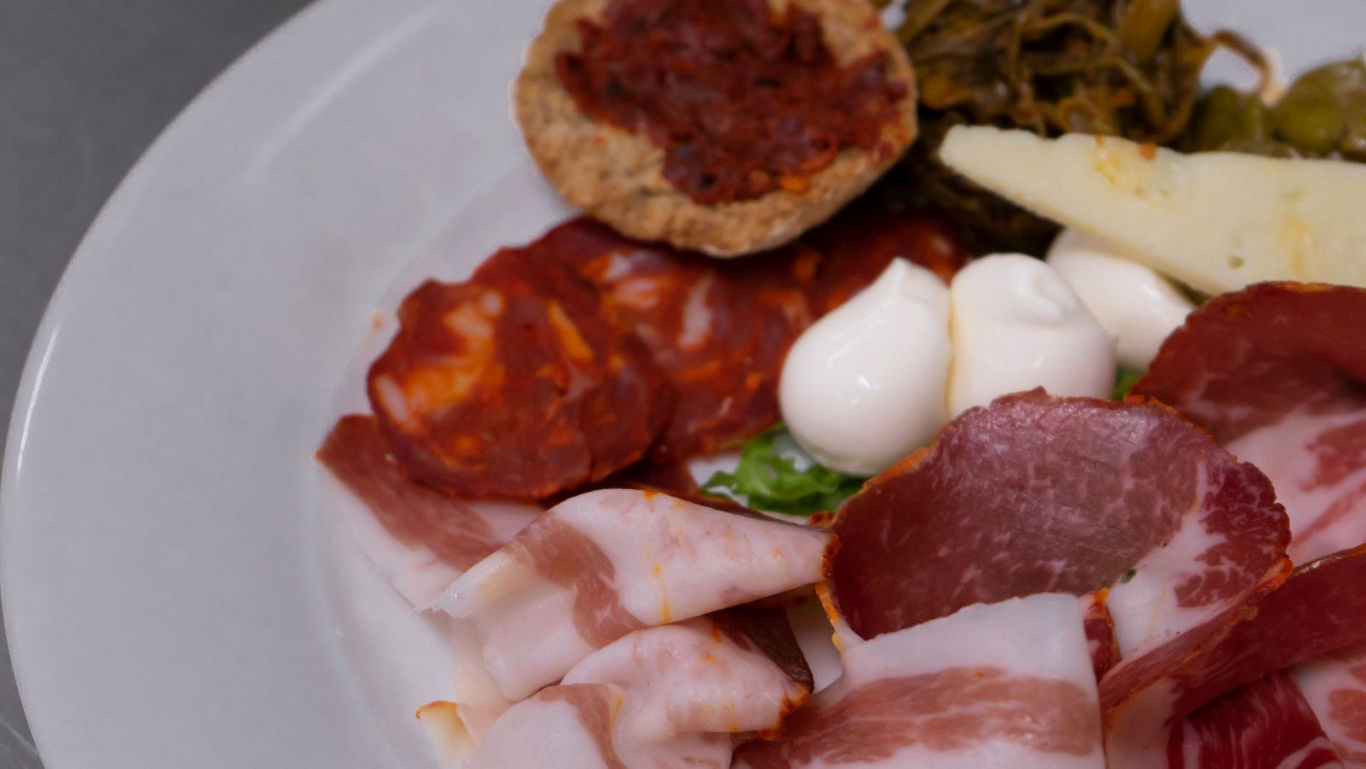 Italian charcuterie plate with cheese and vegetables
