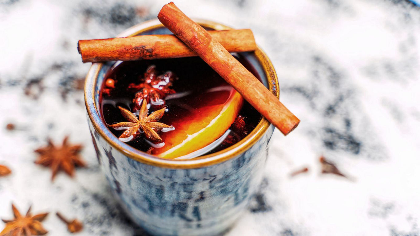 Warm spiced drink with cinnamon sticks