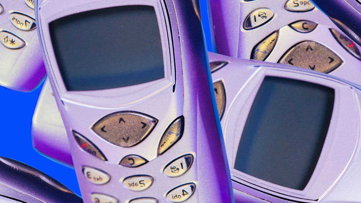 Retro mobile phones on vibrant blue background
