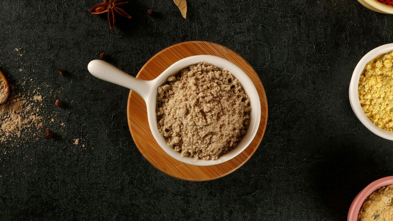 Bowl of ground spice on dark surface