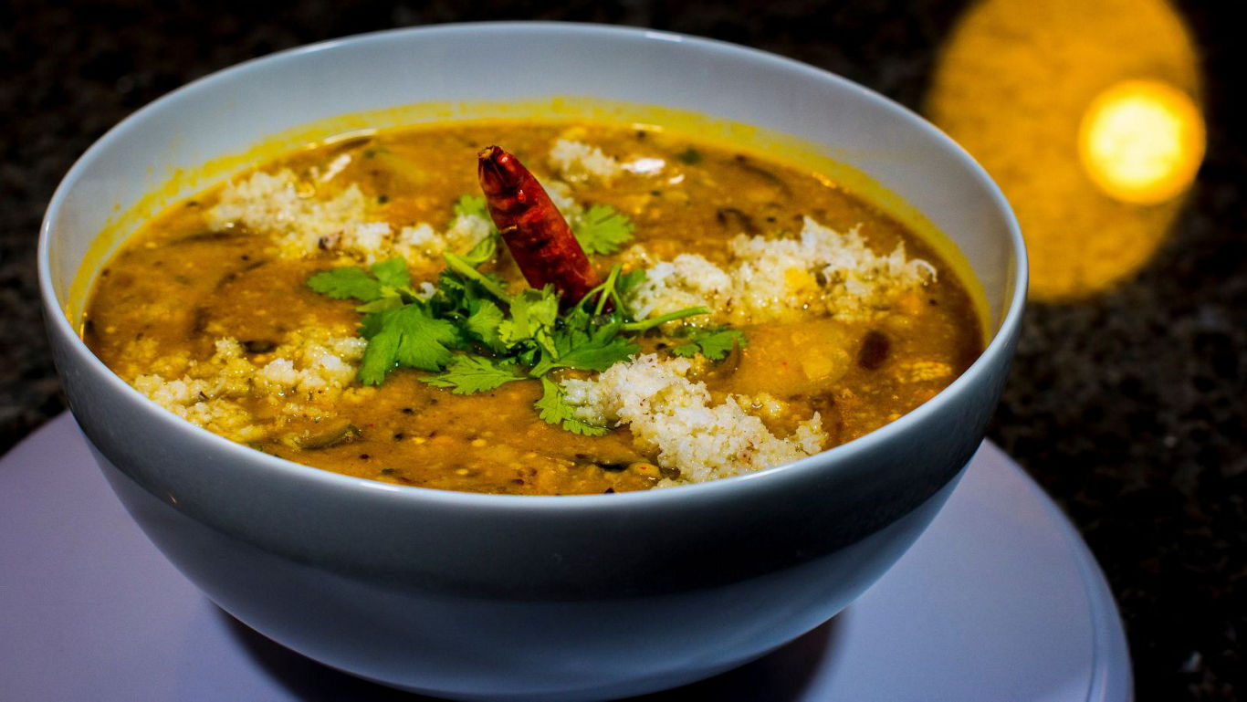 Spicy lentil curry in white bowl