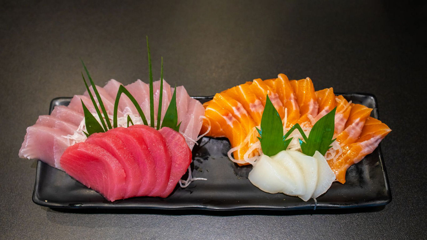Assorted sashimi platter on black plate