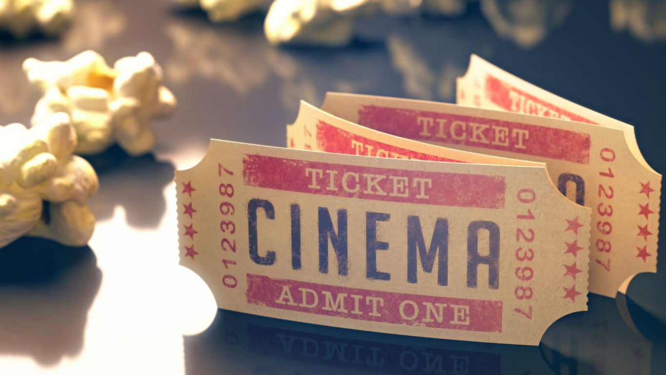 Vintage cinema tickets with scattered popcorn