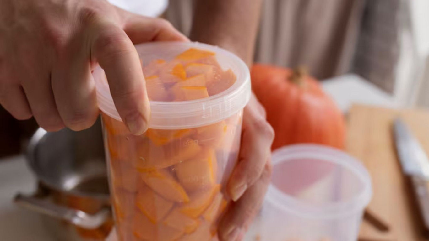 Hand Sealing Container of Fresh Pumpkin Cubes