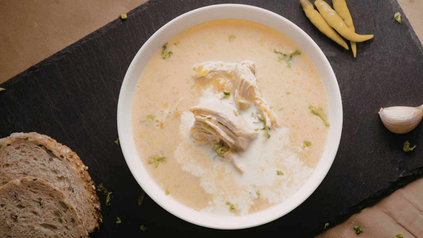 Creamy chicken soup with bread and chili peppers