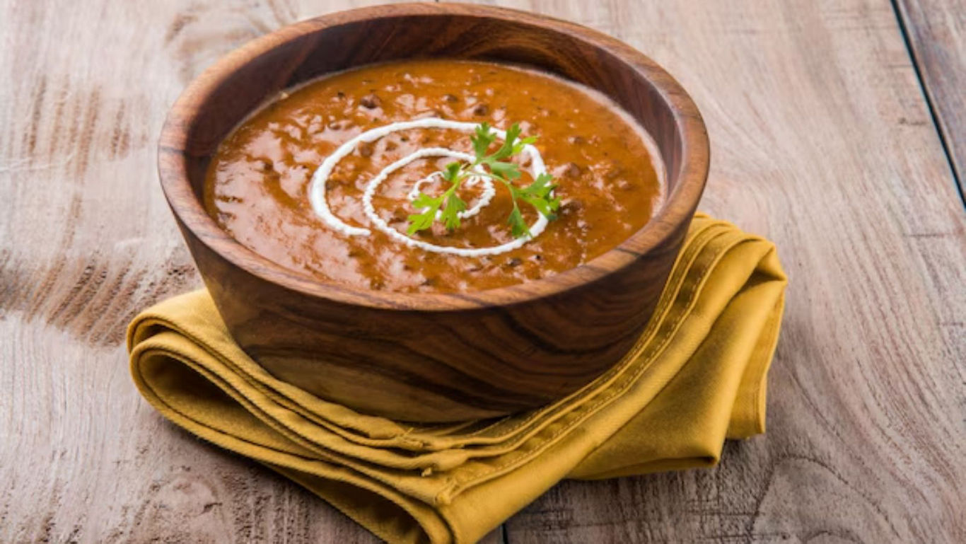 Creamy lentil curry in wooden bowl on napkin