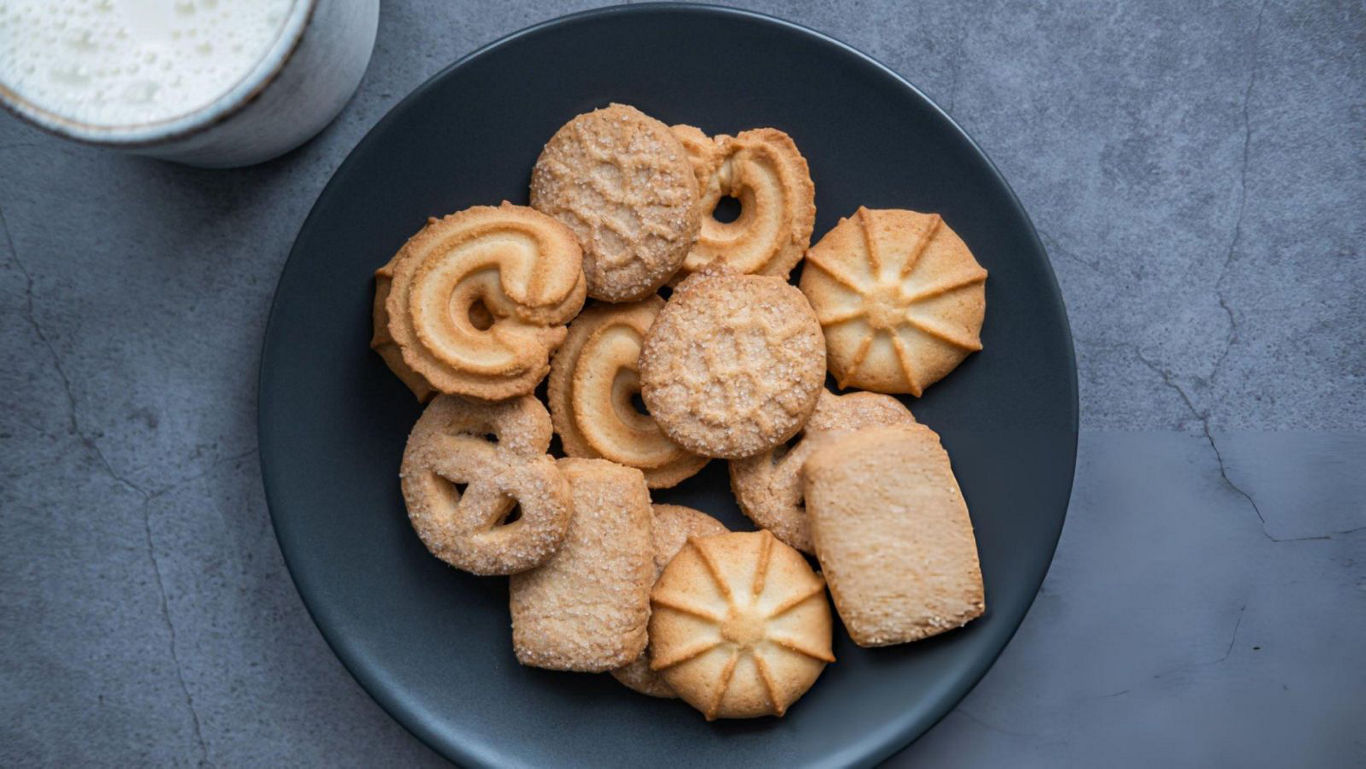 Assorted butter cookies on dark plate