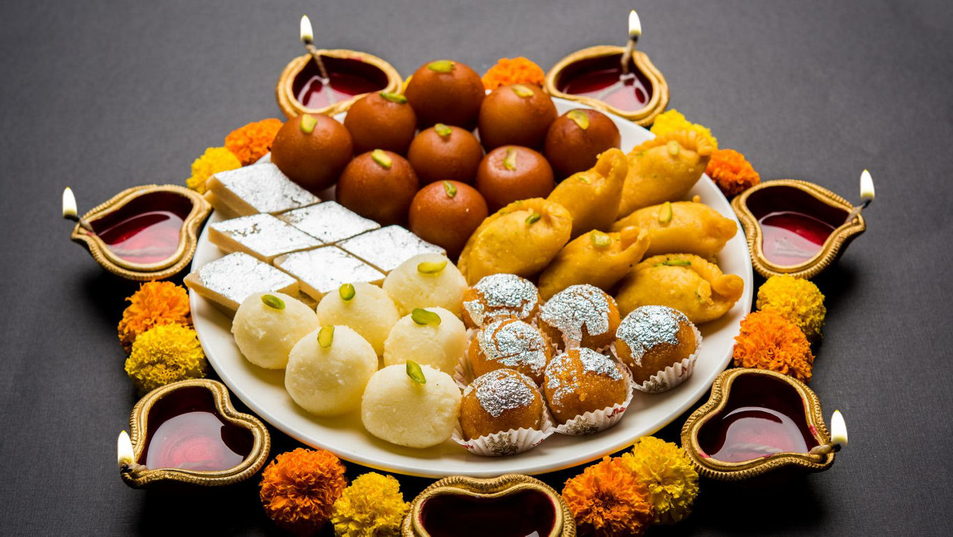 Traditional Indian sweets with festive decor