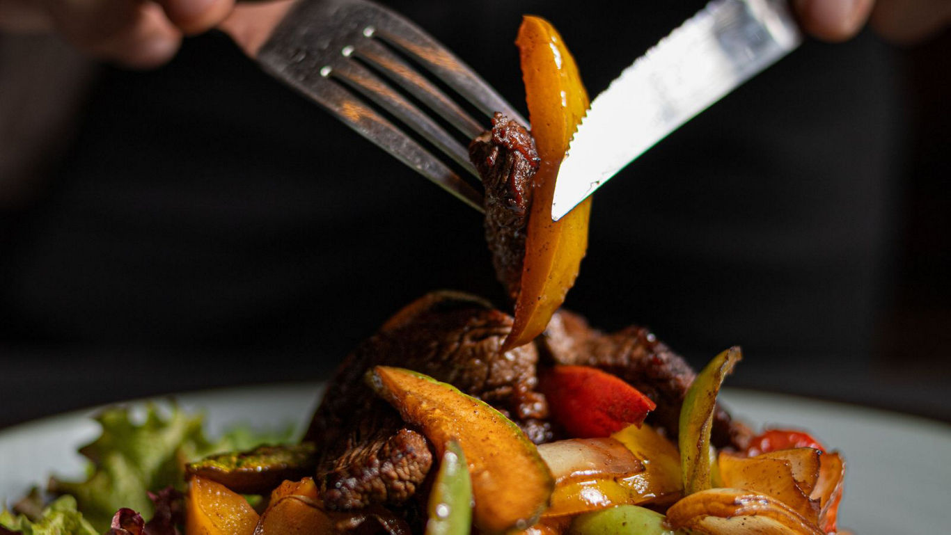 Close-up of fork and knife with stir fry