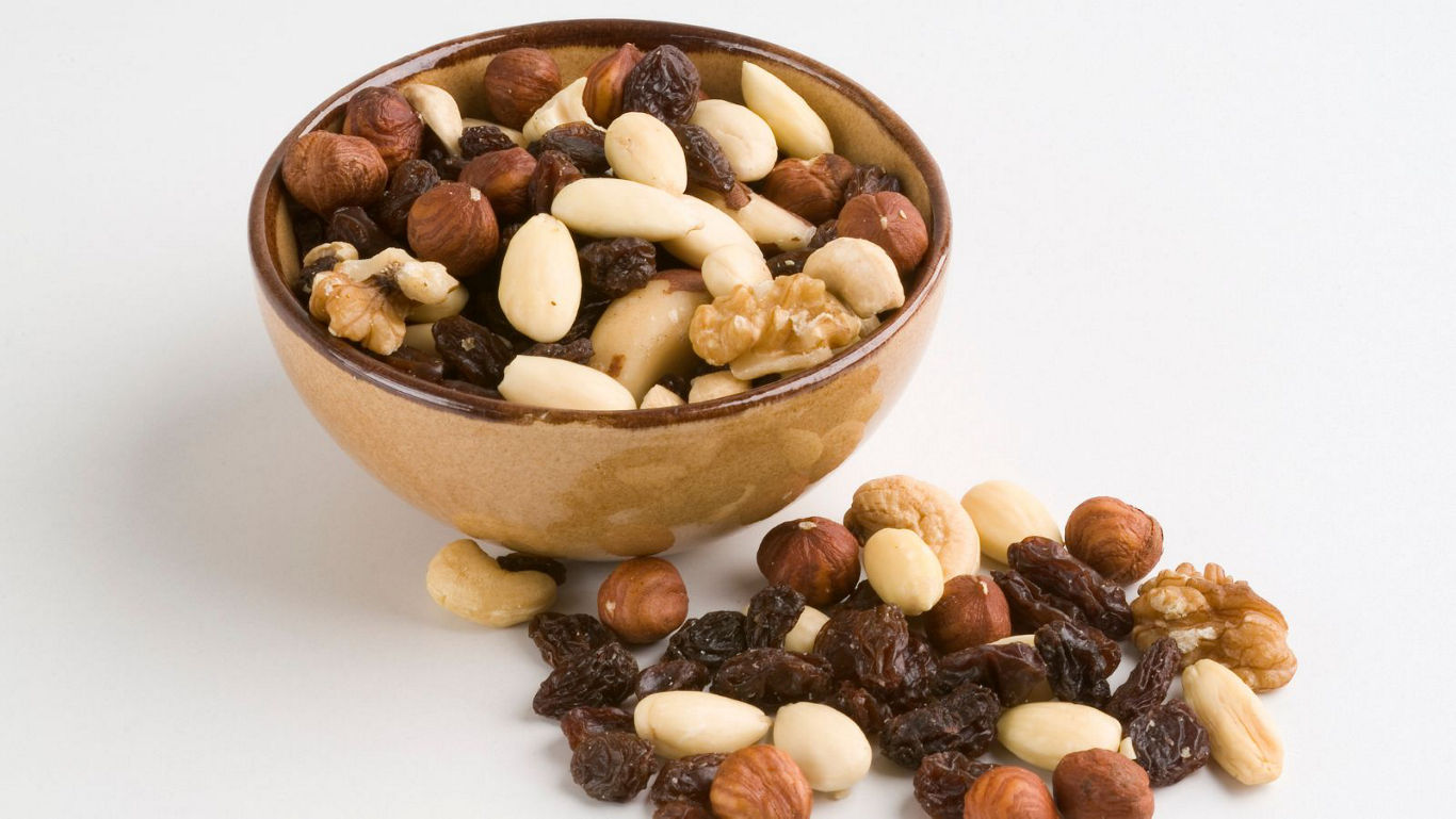 Mixed nuts and raisins in ceramic bowl