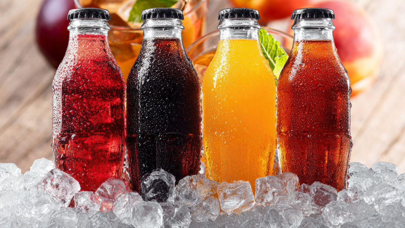 Assorted chilled soft drinks in glass bottles