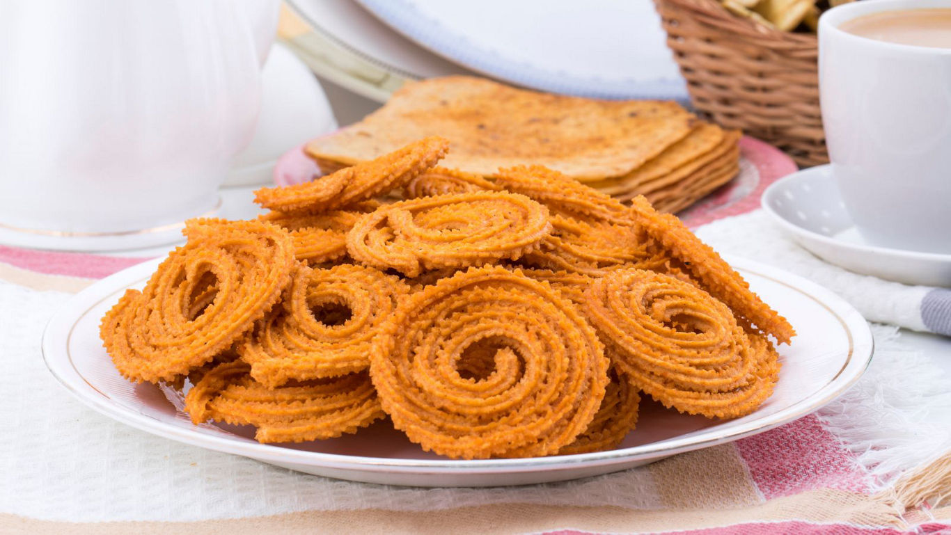 Plate of crispy spiral Indian snacks