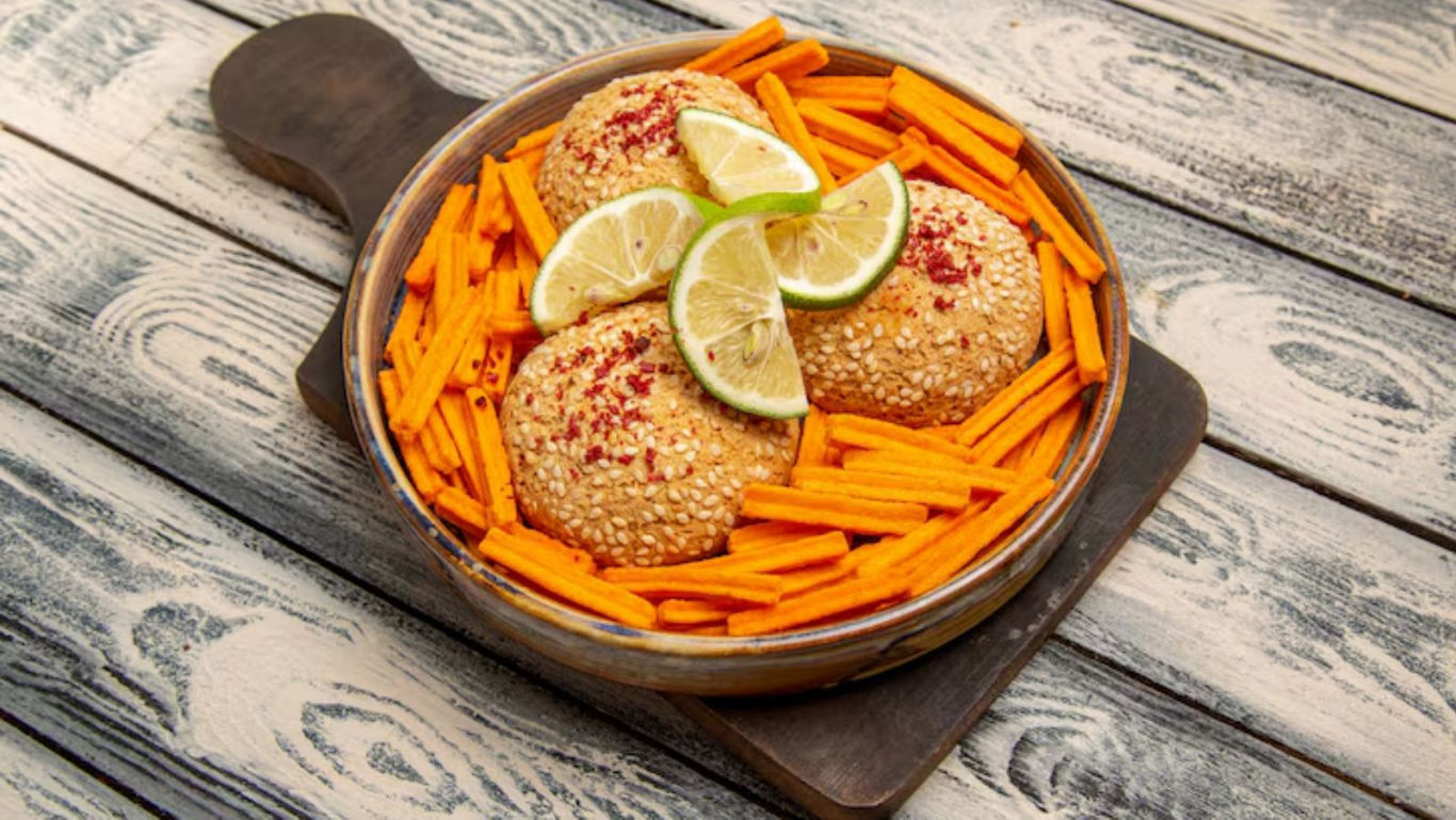 Sesame-coated patties with lime garnish