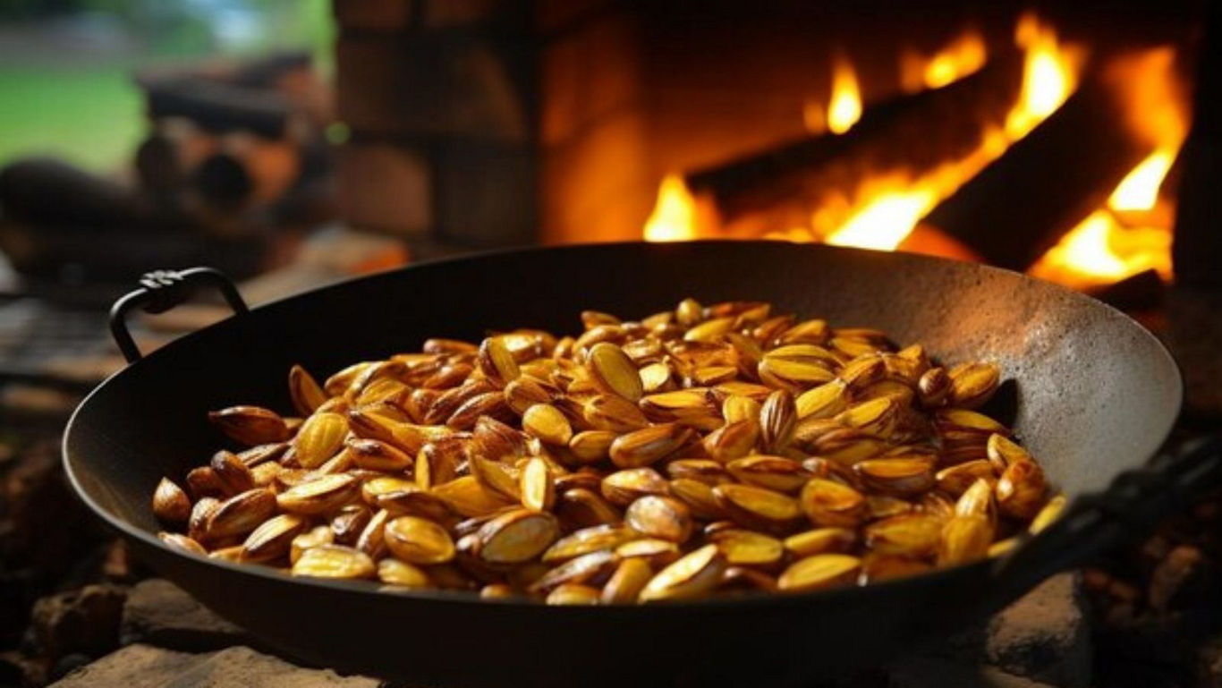 Golden Potatoes Roasting in Cast Iron Pan Over Fire
