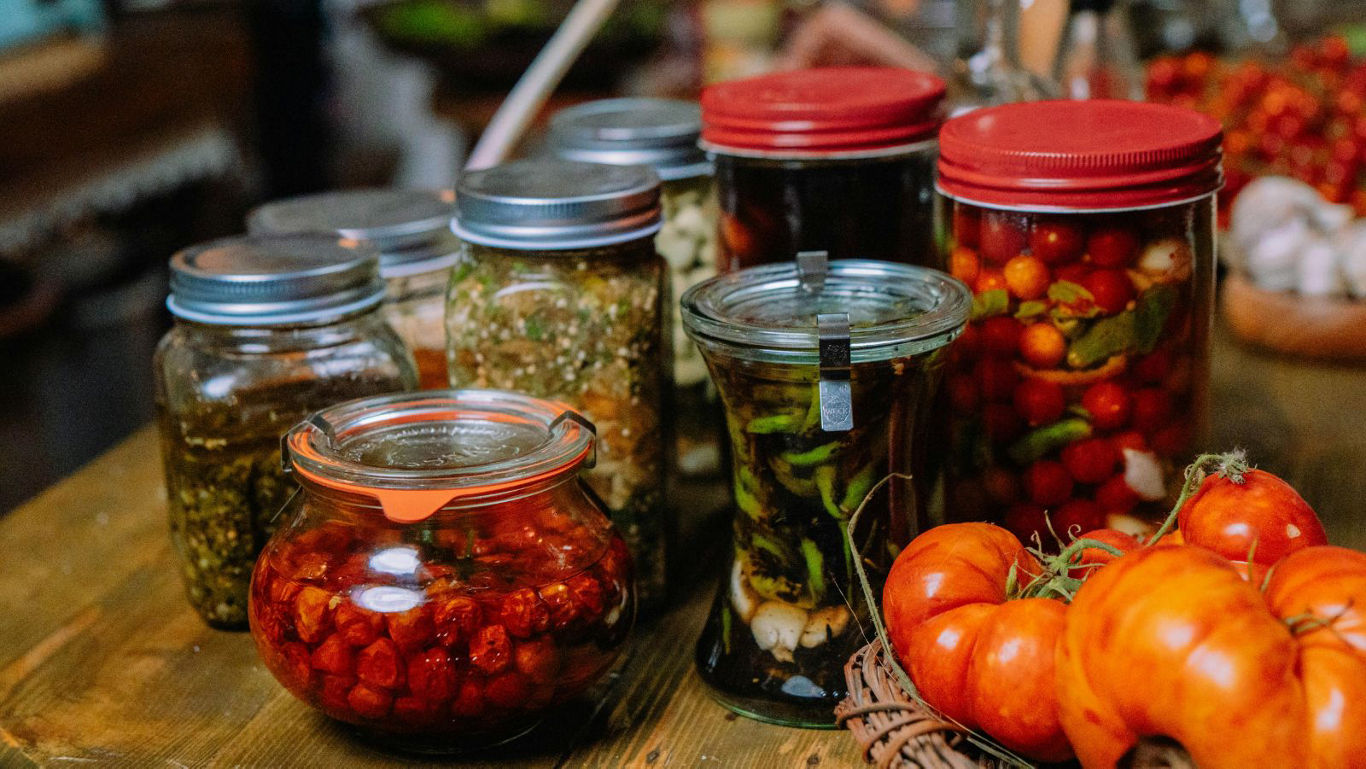 Assorted Homemade Preserves in Glass Jars on Table