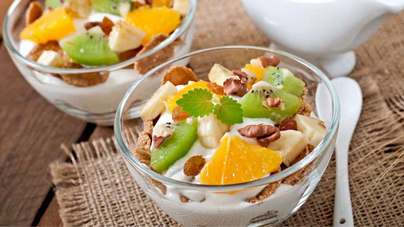 Fresh fruit and nut yogurt parfait in glass bowls