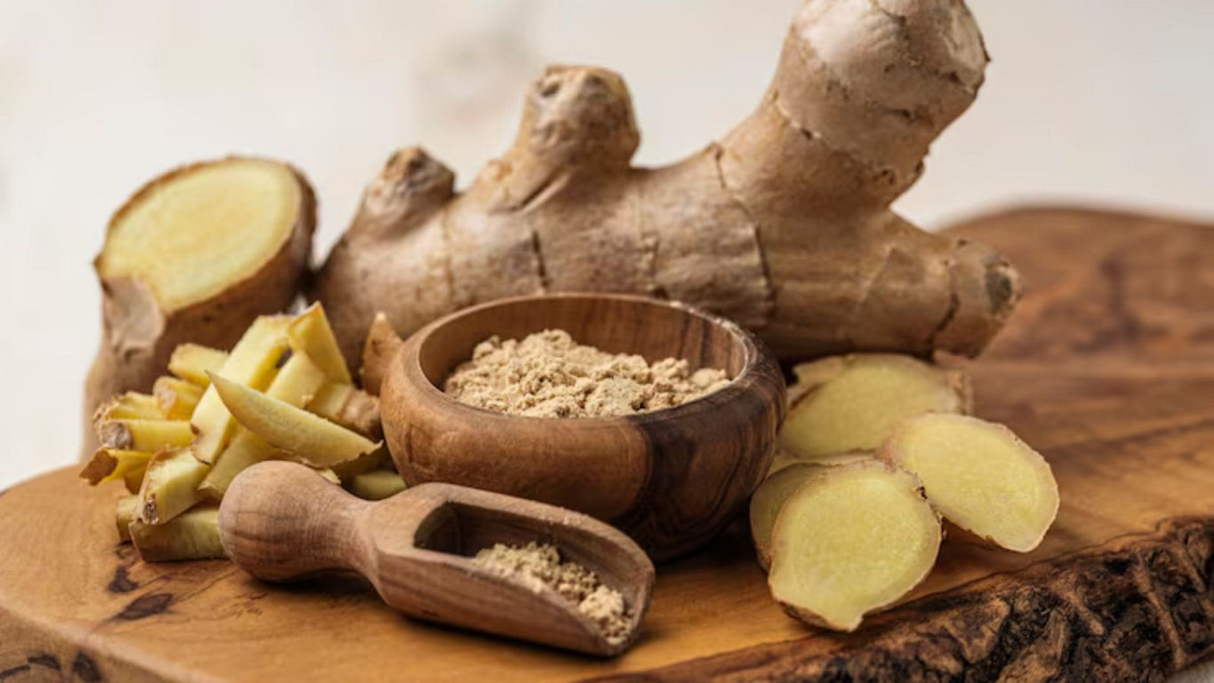 Fresh and powdered ginger on wooden board