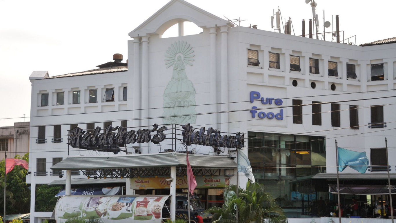 Large White Building with Pure Food Signage
