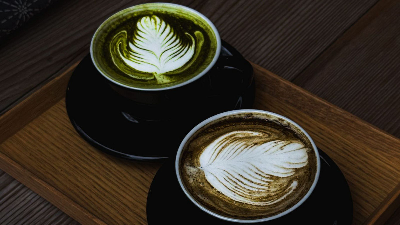 Two artisan lattes with leaf latte art