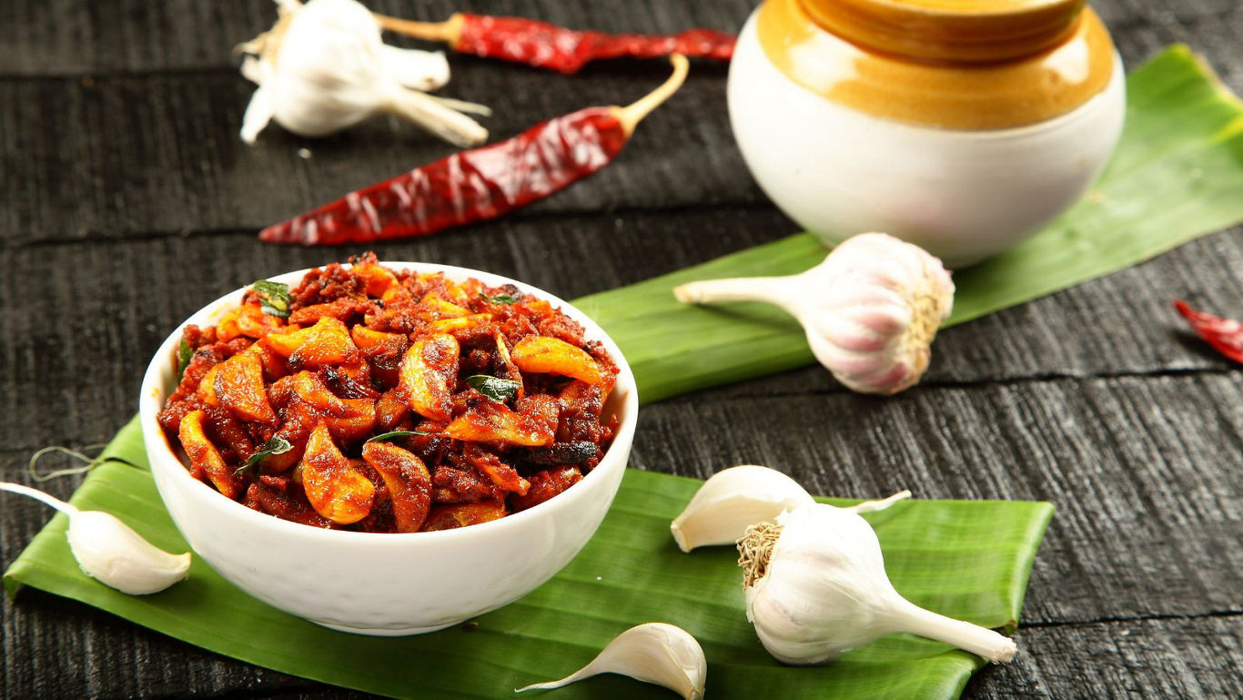 Spicy Garlic Pickle in White Bowl on Banana Leaf