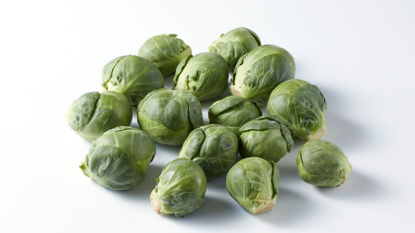 Fresh green Brussels sprouts on white