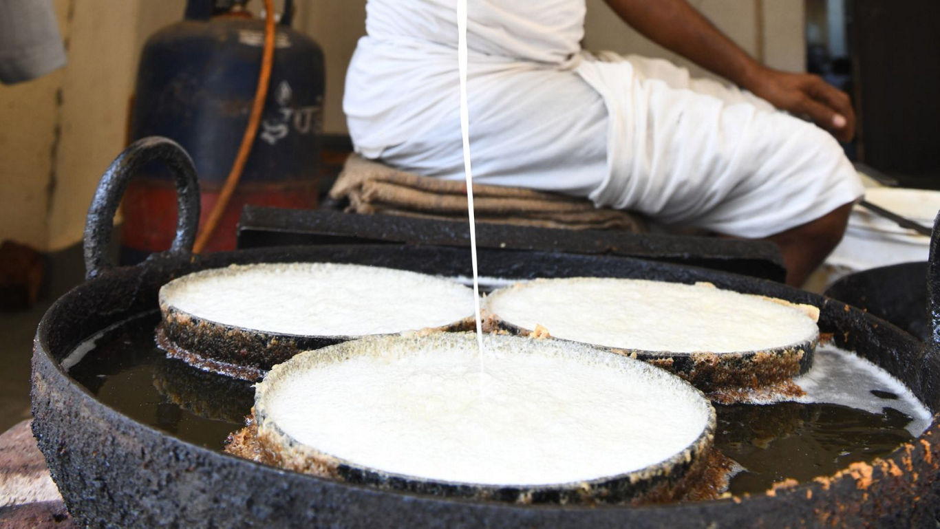 Traditional street vendor preparing rice pancakes