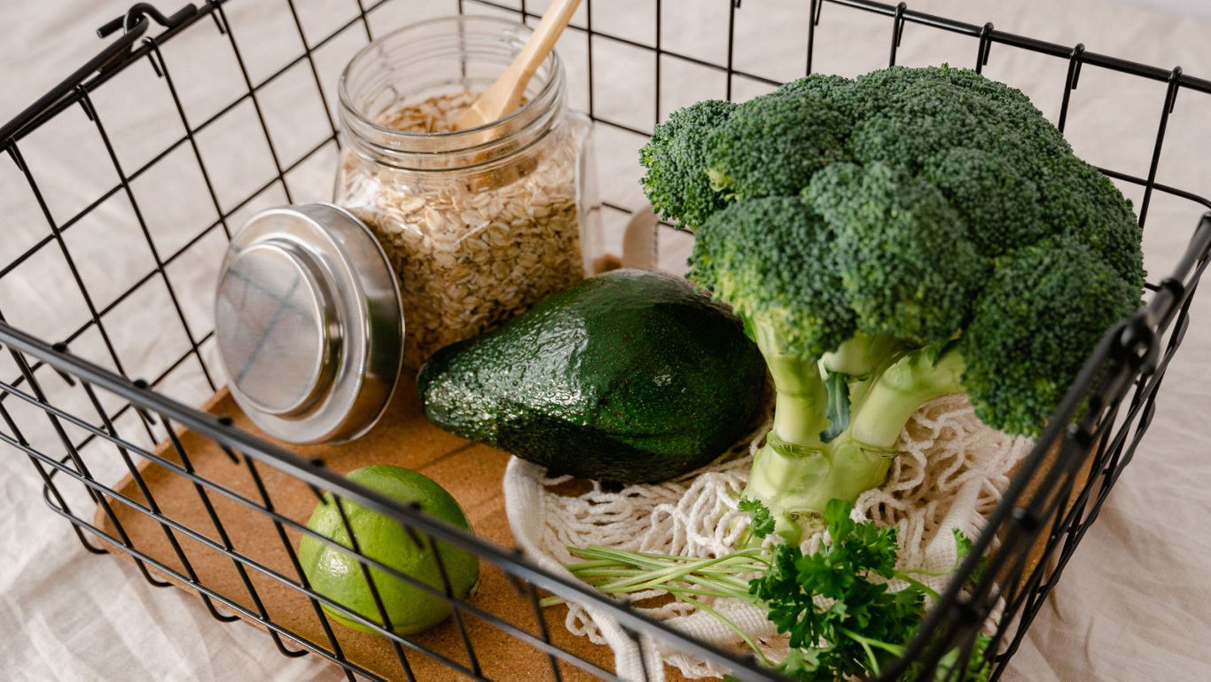 Fresh green vegetables and grains in basket