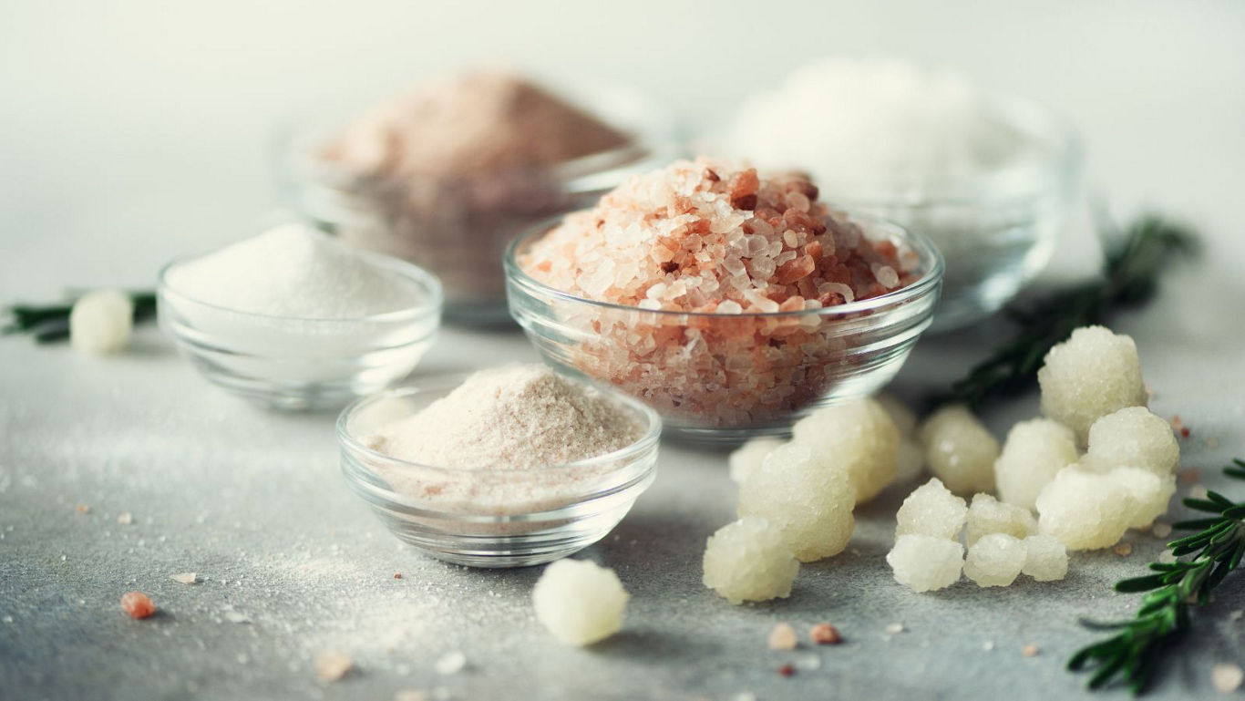 Assorted gourmet salts in glass bowls