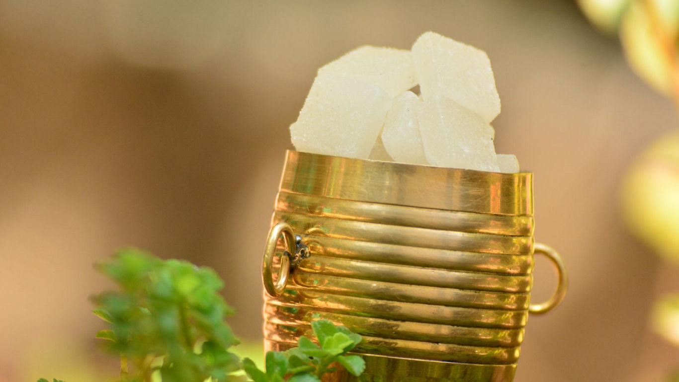 Golden cup filled with sugar cubes