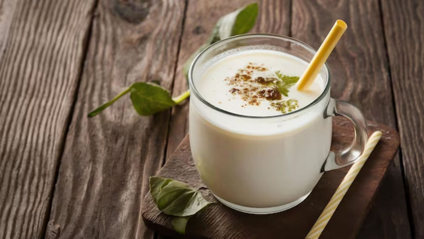 Traditional Spiced Buttermilk in Glass Mug on Wood