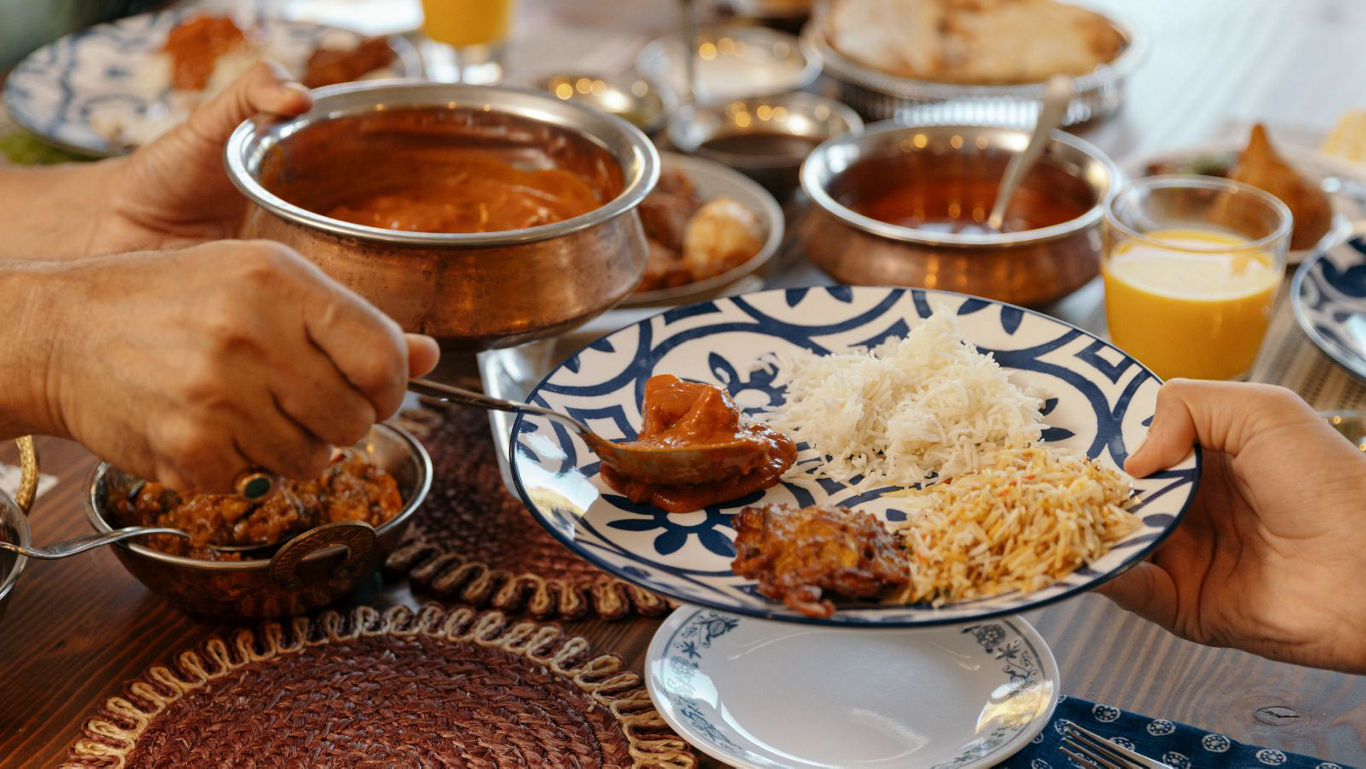 Serving curry and rice at festive meal