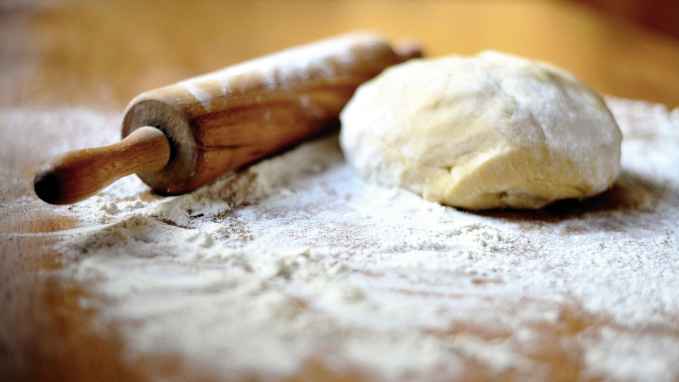 Ball of dough with rolling pin on counter