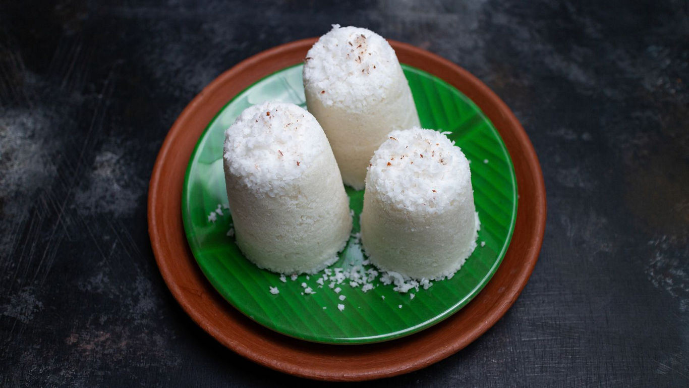 Traditional steamed rice cakes on banana leaf