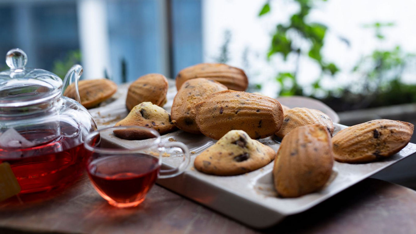 Fresh madeleines served with herbal tea