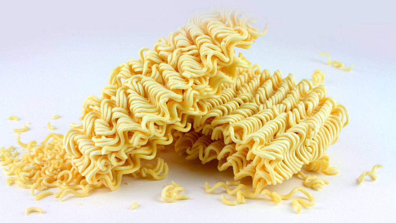 Dry instant noodle bricks on white background