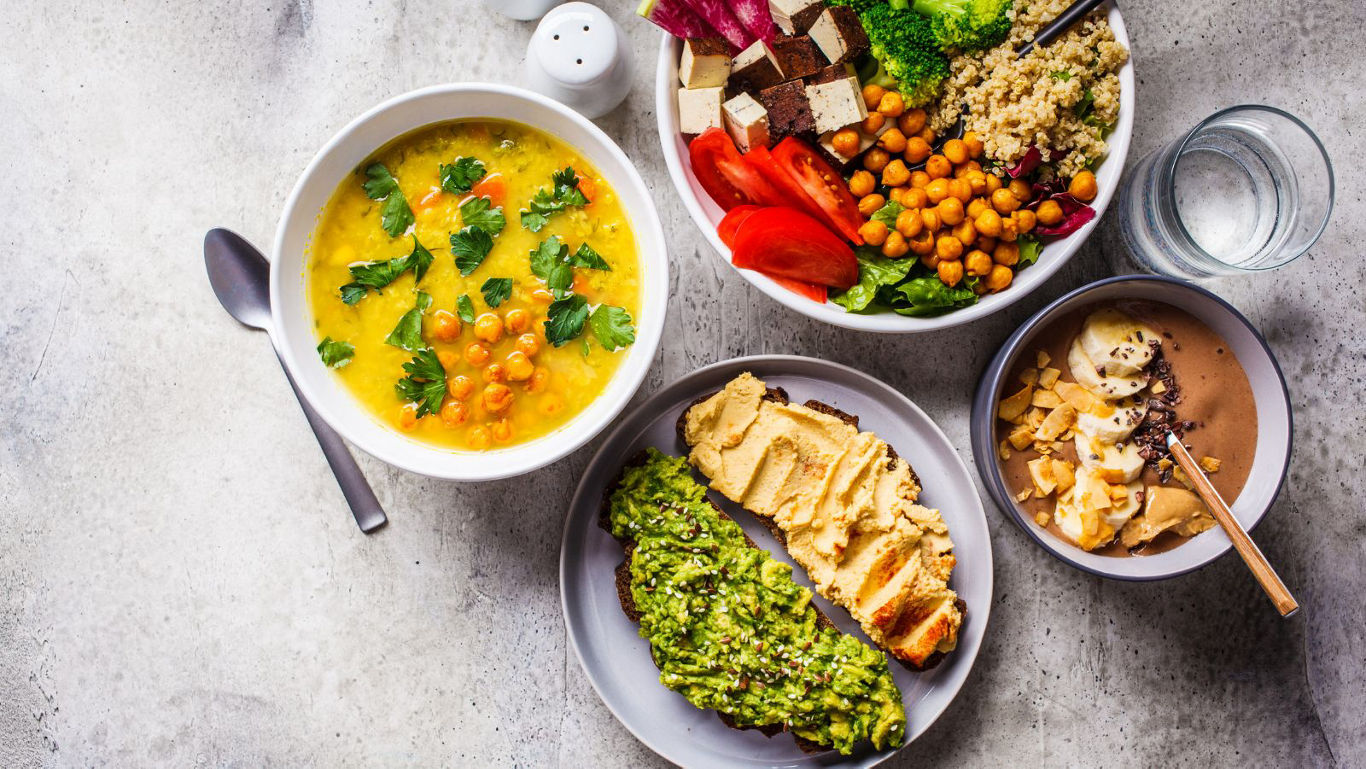 Colorful vegan bowls with soup and toast