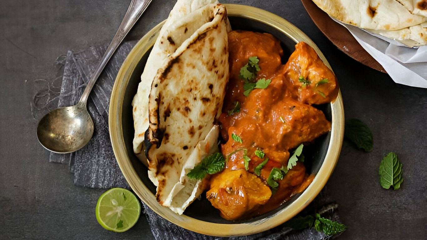 Indian Butter Chicken with Naan and Fresh Herbs