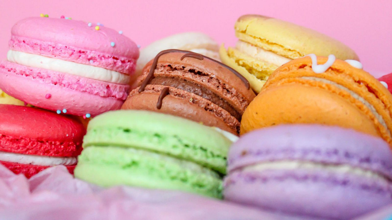 Colorful Assorted Macarons on Pink Background