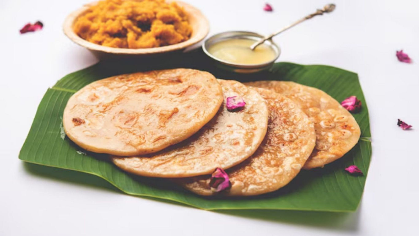 Traditional Indian sweet pancakes on banana leaf