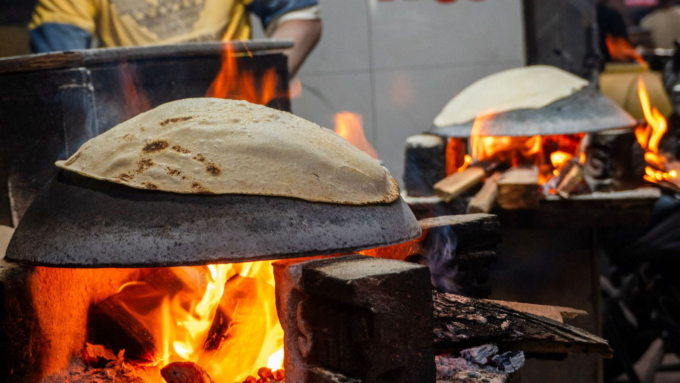 Flatbread cooking over open wood fire