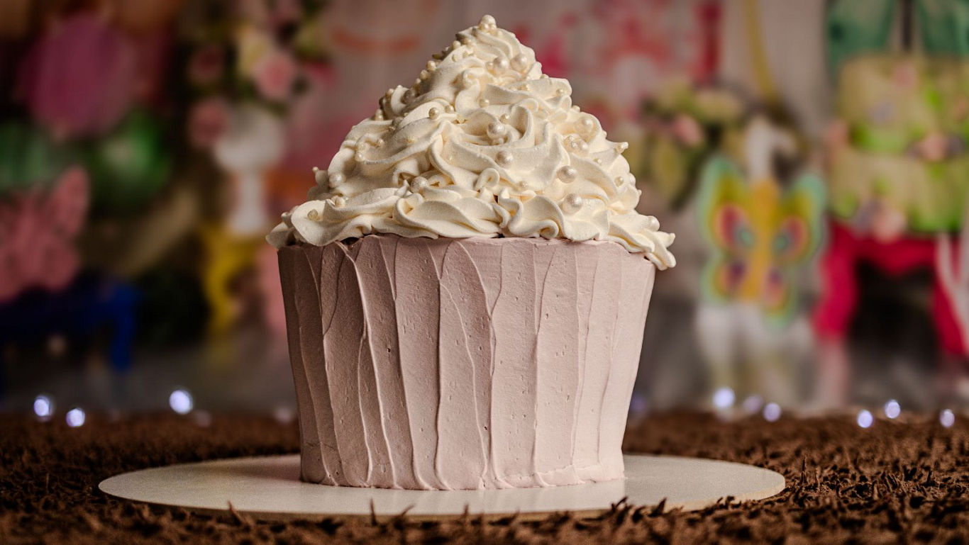 Large frosted cupcake on festive background